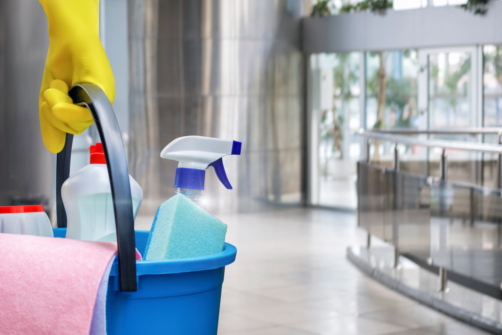 janitor holding cleaning supplies